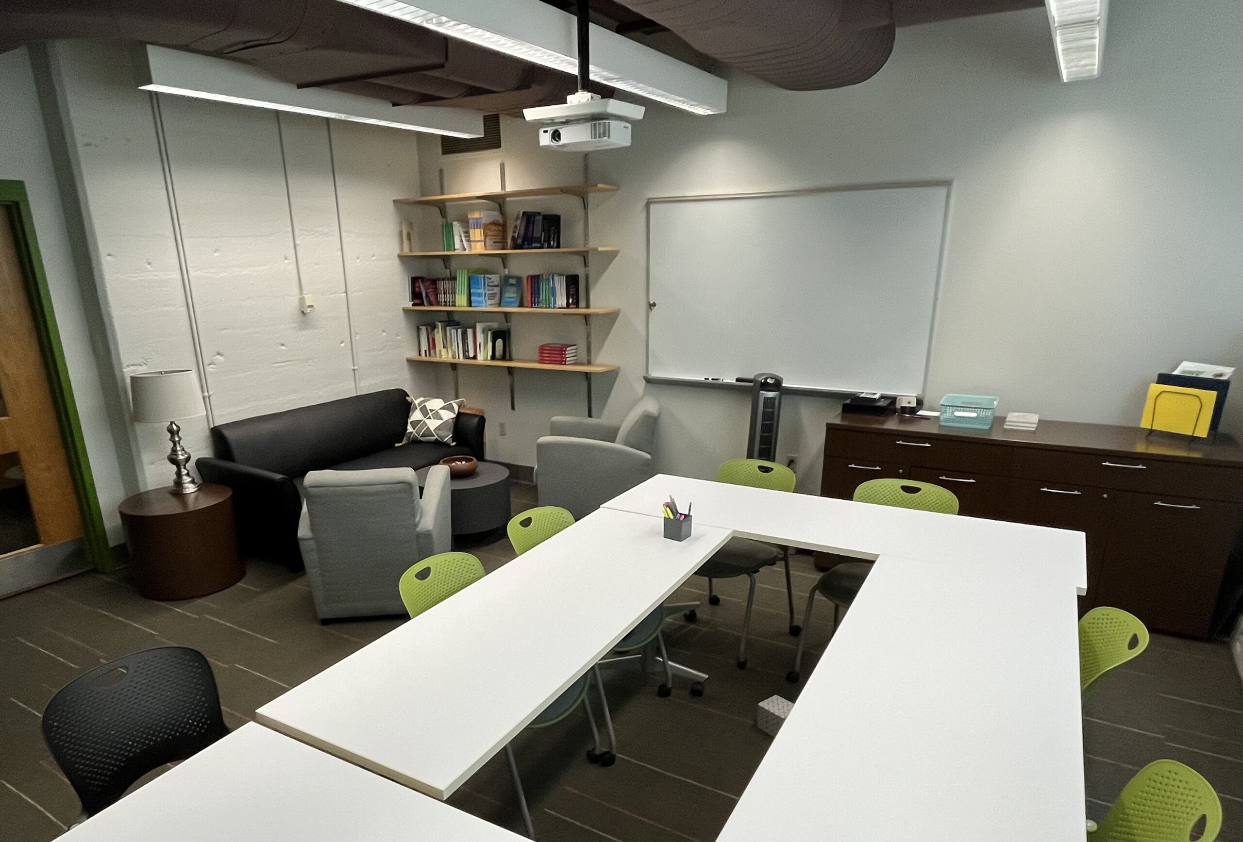 View of tables, chairs, armchairs, and lending library.